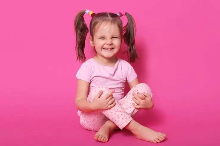 Indoor Laughing Positive Kid Sitting On Floor Posing Isolated On Pink Wearing Rose T Shirt And Trousers Having Ponytails Being In High Spirits Childhood Concept 176532 8719