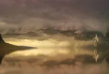 Stunning landscape of a storm over an island with lightning striking the calm water.