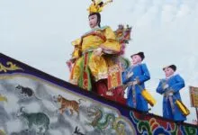 Colorful traditional parade float featuring zodiac symbols and ornate figures.