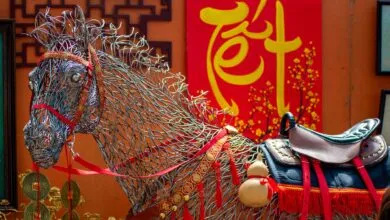 Colorful wire horse sculpture and Tet decorations create a festive scene outdoors.