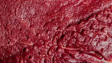 Detailed macro shot of raw beef showcasing texture and marbling.