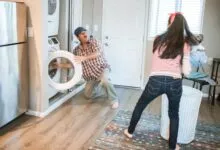 A man and woman doing laundry together in a modern home setting.