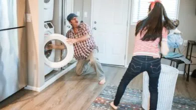 A man and woman doing laundry together in a modern home setting.