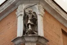 Detailed view of St. Michael Archangel statue on a historic building in C&aacute;diz, Spain.