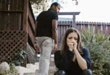 A couple facing emotional struggles captured in an outdoor setting.