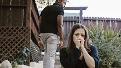 A couple facing emotional struggles captured in an outdoor setting.